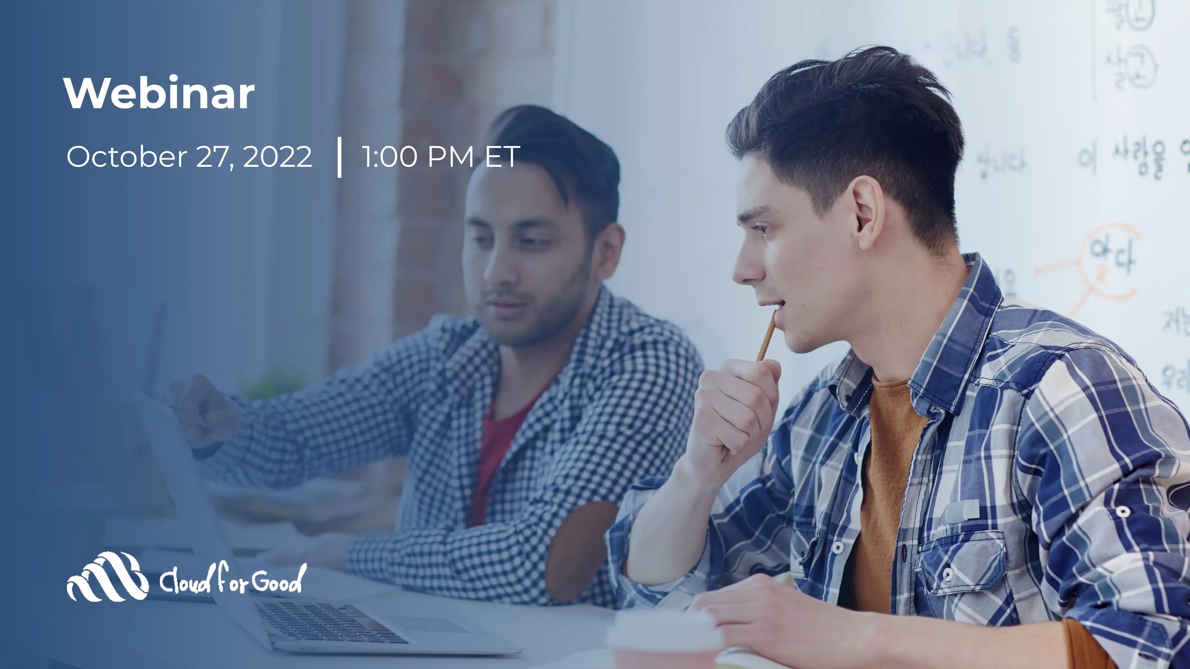 Two men at a table, one gesturing at a laptop, the other holding a pencil to his chin thoughtfully