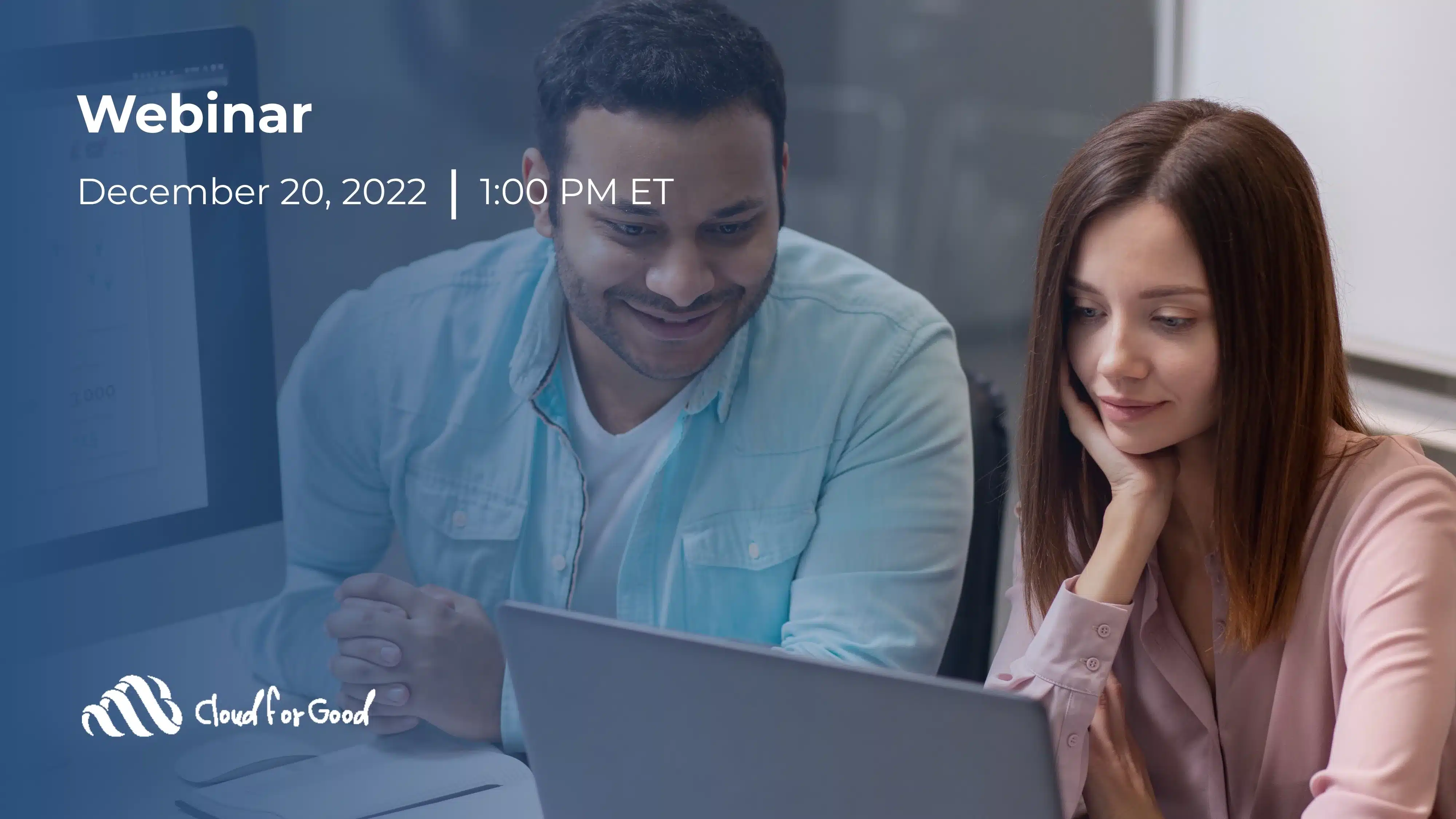 Man and woman smiling while looking at a laptop screen together