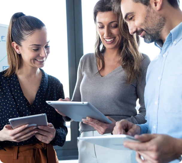 Business team using tablets to collaborate on Salesforce technology strategy