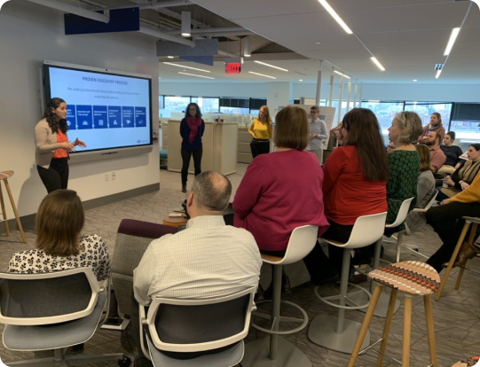 Team presentation in a modern office discussing Salesforce marketing automation strategies and audience engagement