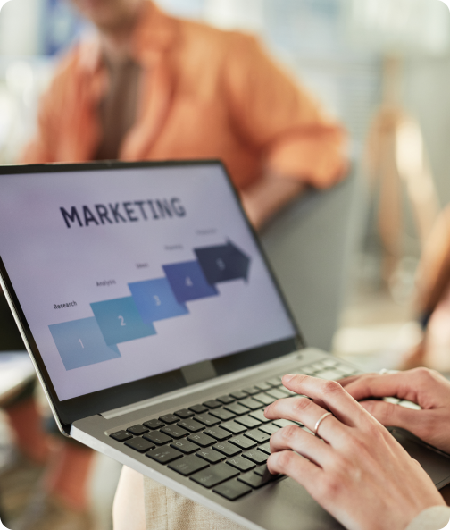 Person using a laptop displaying a marketing automation workflow and customer journey strategy