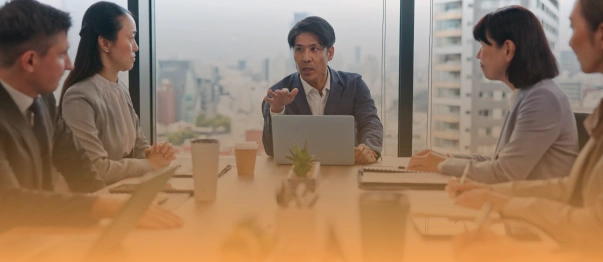 Business team having a meeting around a conference table with a laptop