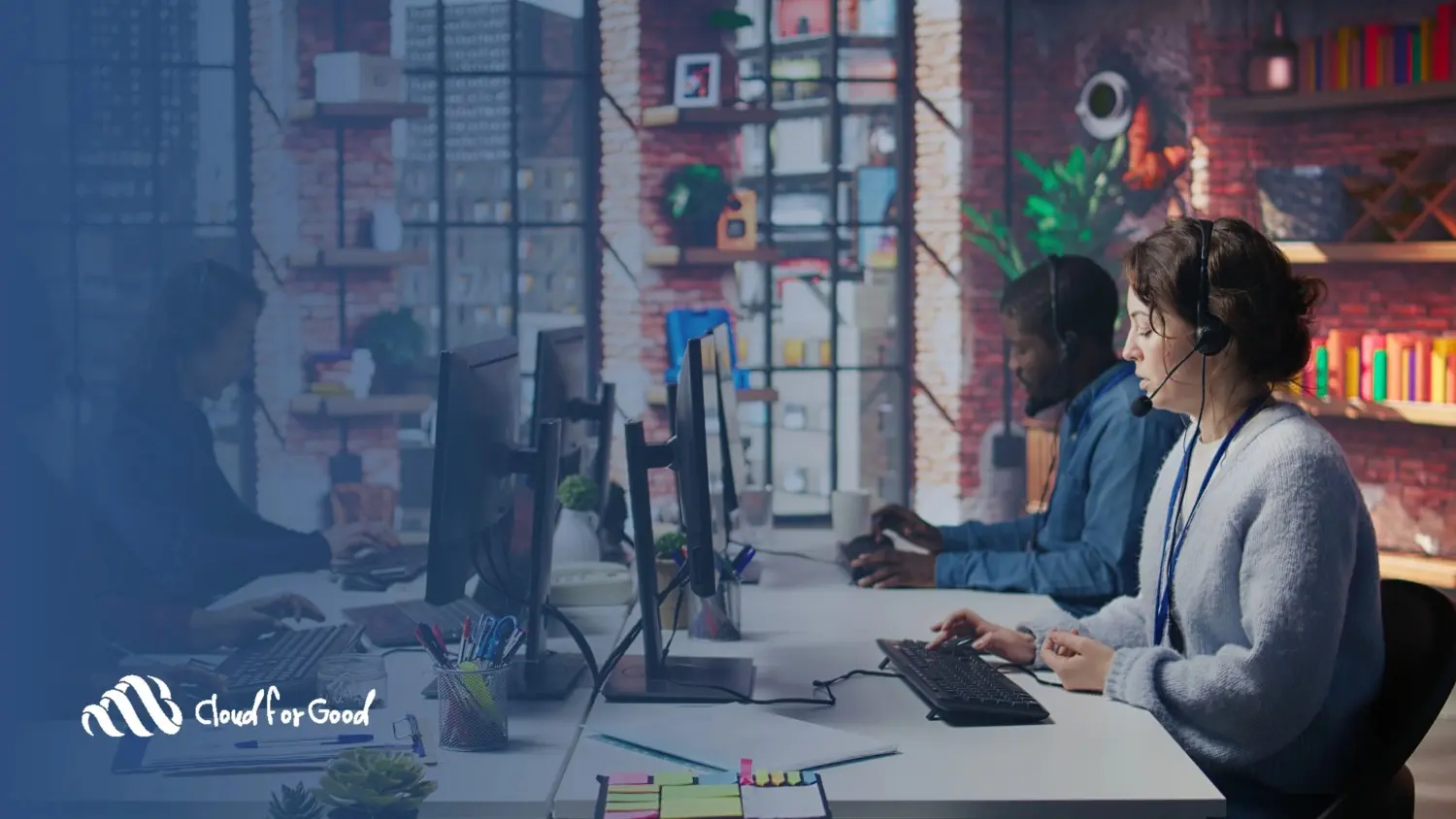 Customer support team with headsets at computers in office - Cloud for Good